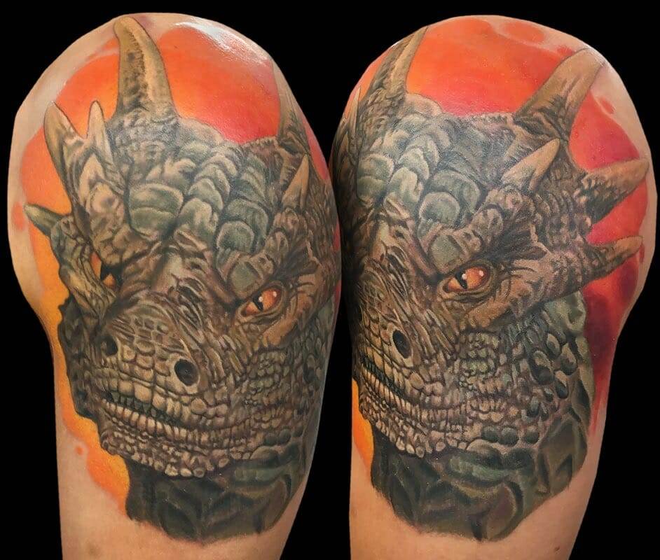 A tattoo of a dragon on a sleeve.