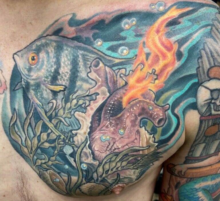 A man with a tattoo of a fish on his chest.