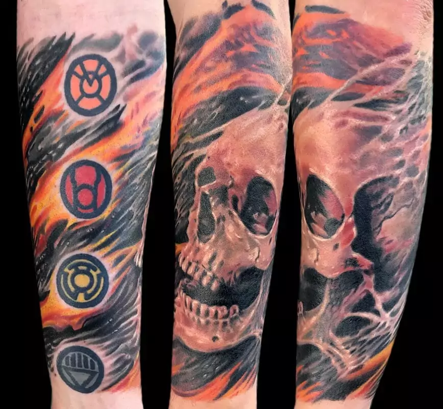 A tattoo of a skull and a symbol on a sleeve.