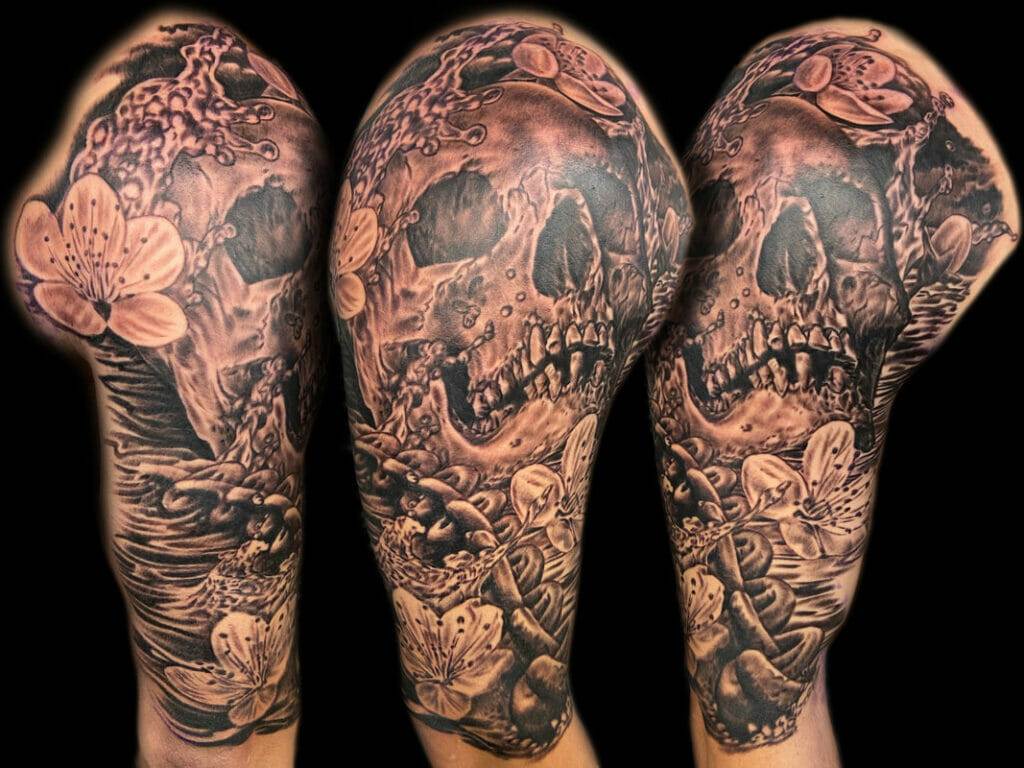 Sleeve tattoo of a woman with a skull and flowers.