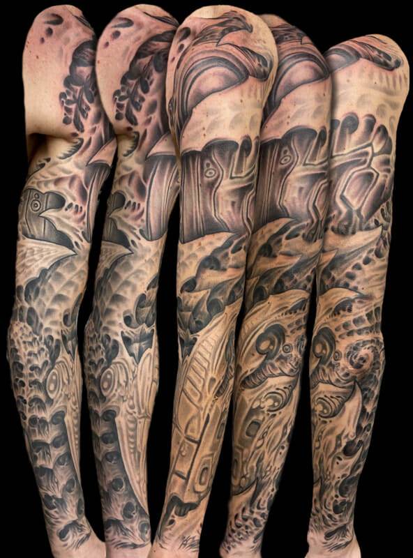 A sleeve of tattoos on a man's arm.