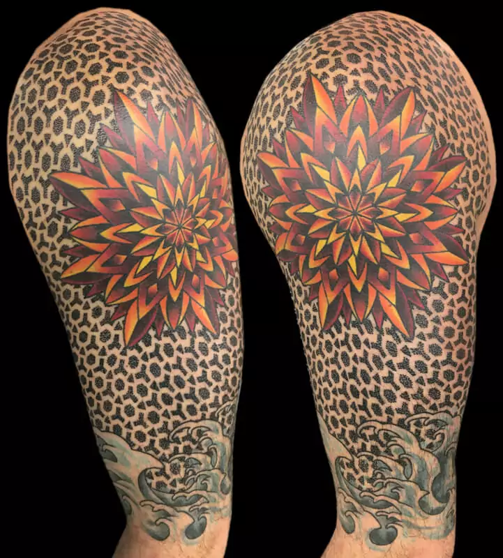 A man's sleeve with a flower tattoo on it.