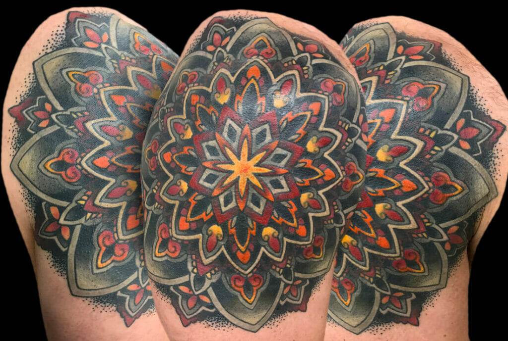 A man with a tattoo of a mandala on his sleeve.