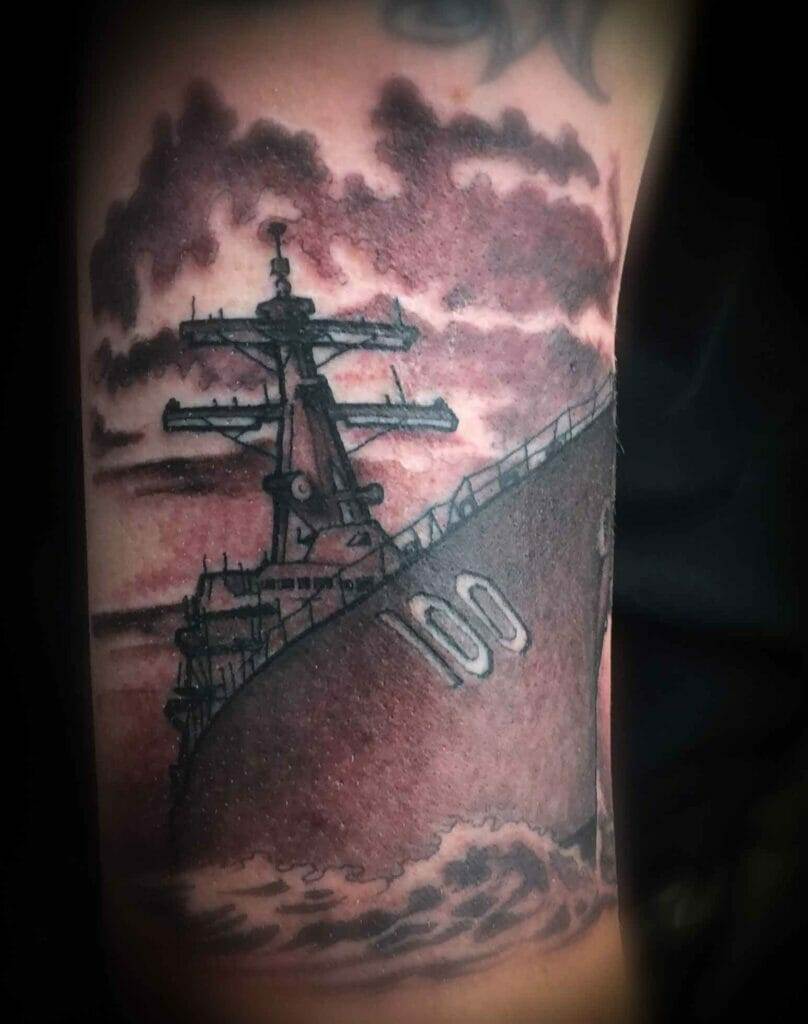 A tattoo of a navy ship on the arm.