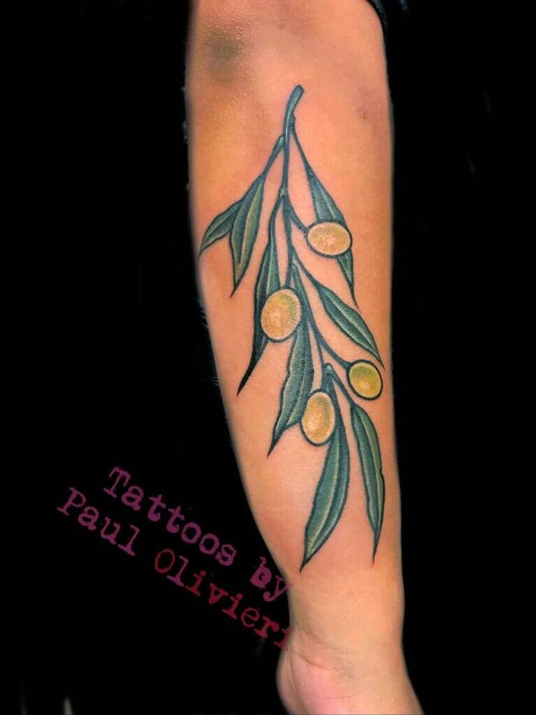 A tattoo of an olive branch on the forearm.