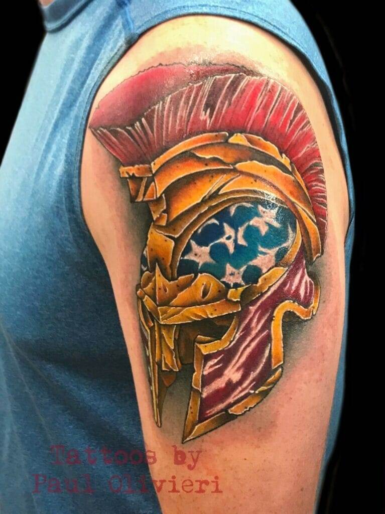 A spartan helmet tattoo on a man's arm.