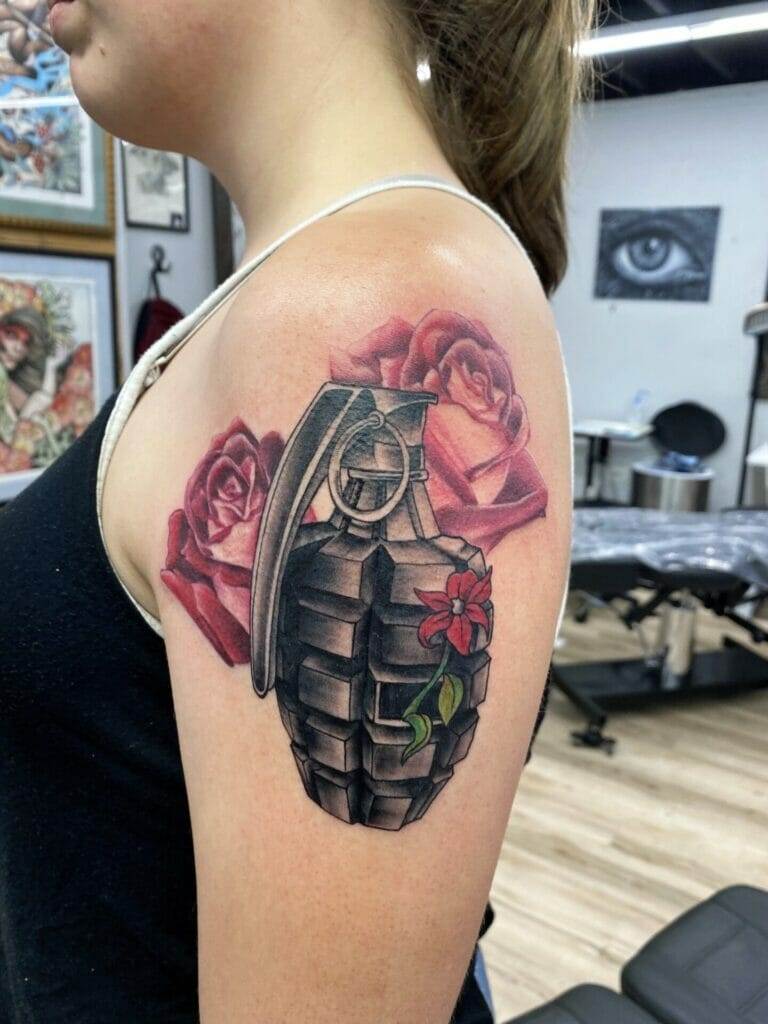 A tattoo of a grenade with roses on it.