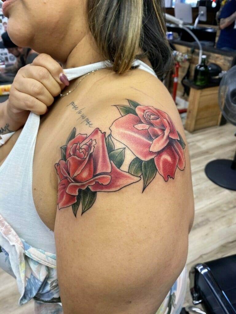 A woman with a tattoo of roses on her shoulder.