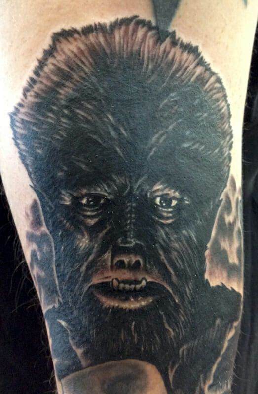 A tattoo of a werewolf on a man's arm.