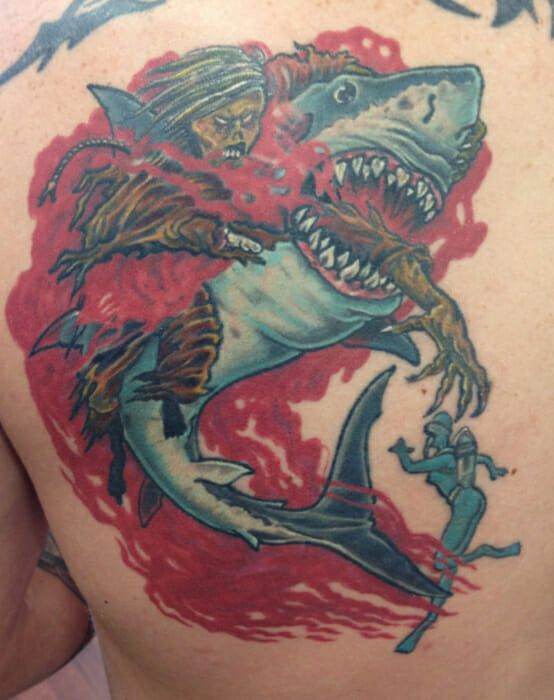 A man with a shark tattoo on his back.