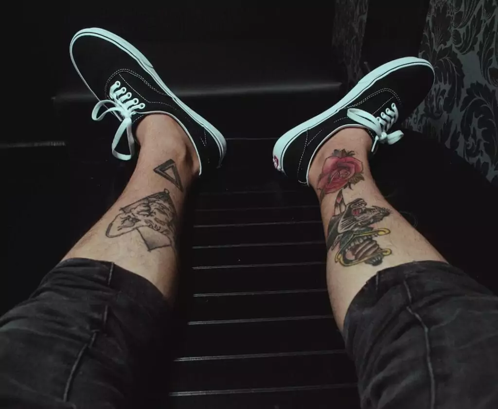 A person's legs with tattoos on them.