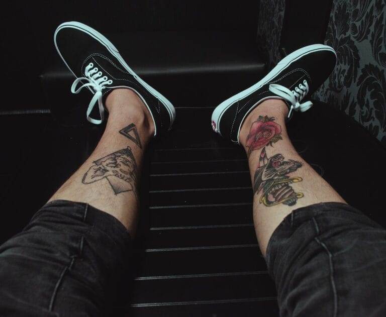 A person's legs with tattoos on them.