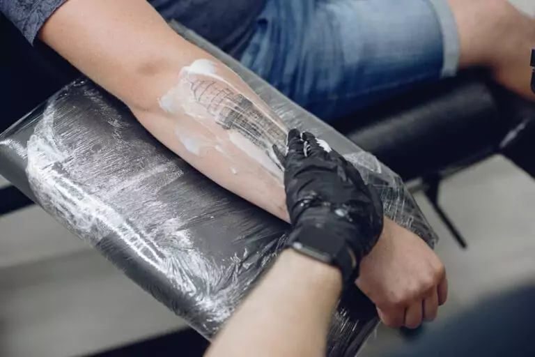 A man is getting a Neo-Traditional tattoo on his arm