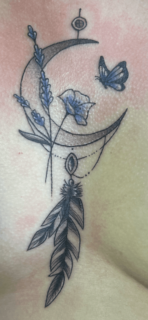Tattoo of a crescent moon, lavender sprig, butterfly, and feather with geometric elements.