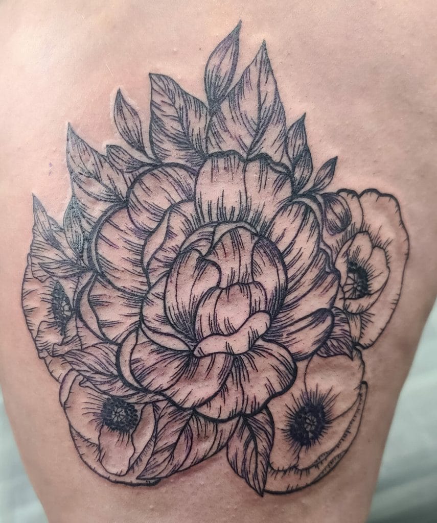 Outline of a detailed floral tattoo with roses and leaves on skin.