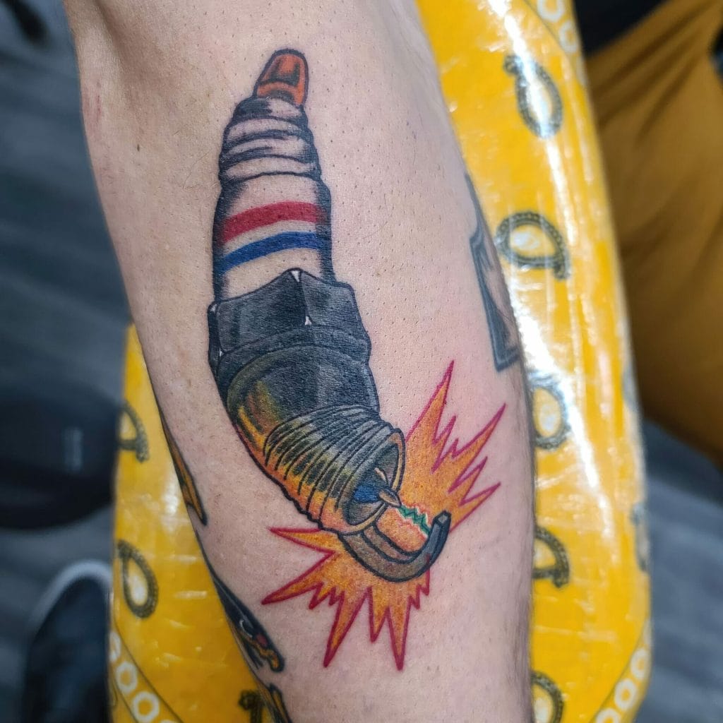 Tattoo of a lit cigarette with a spark, wearing a barbers pole pattern, on skin.