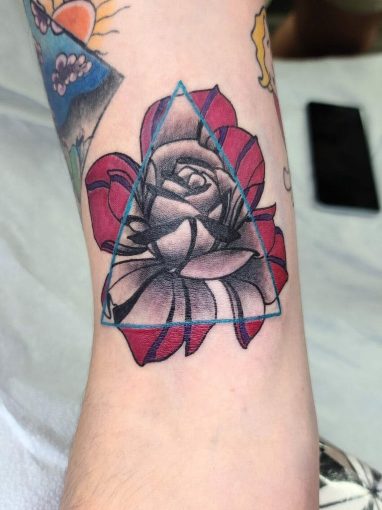 Black and gray rose with red petals, overlaid by a blue geometric triangle outline.