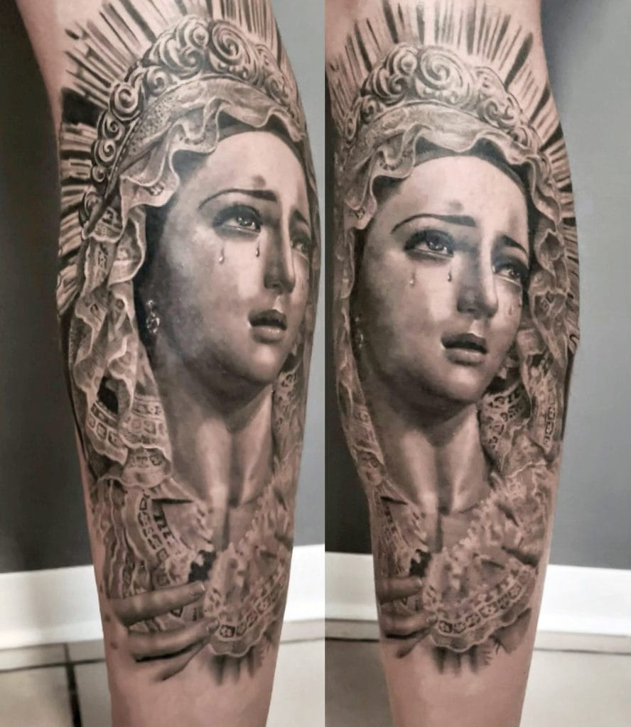 Black and gray tattoo of a crying woman with a halo, holding a rosary.