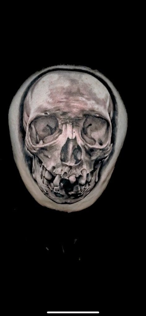 Skull with exaggerated facial features on a black background.