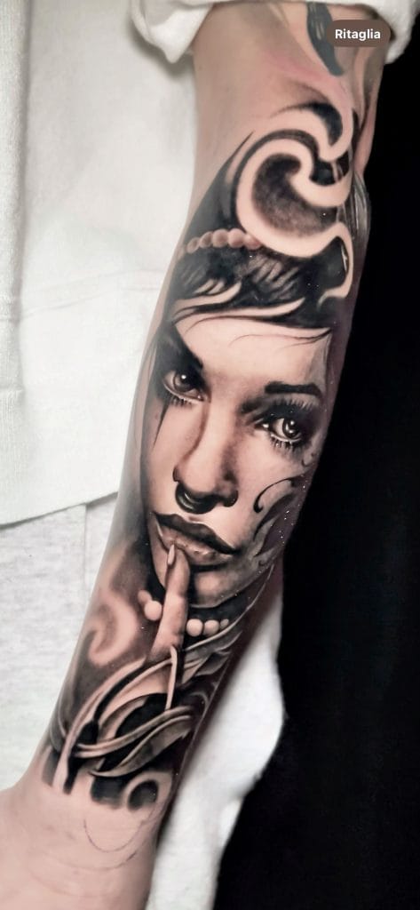 Realistic black and gray portrait of a woman with finger to lips, surrounded by abstract designs.