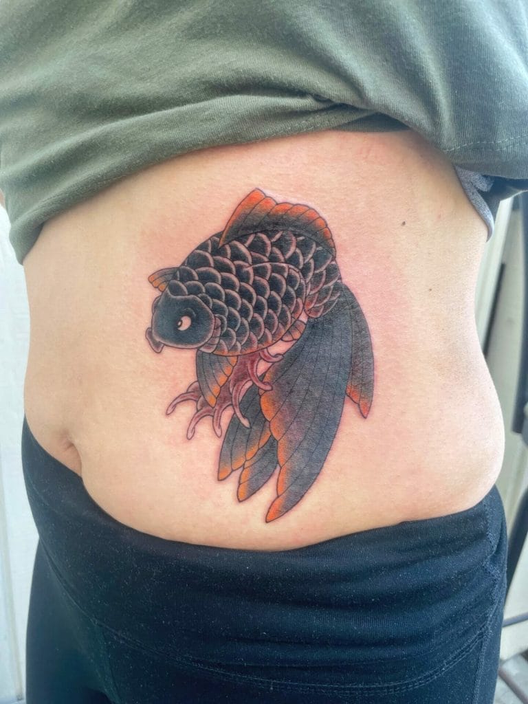Colorful koi fish tattoo with detailed scales and flowing fins on persons side.
