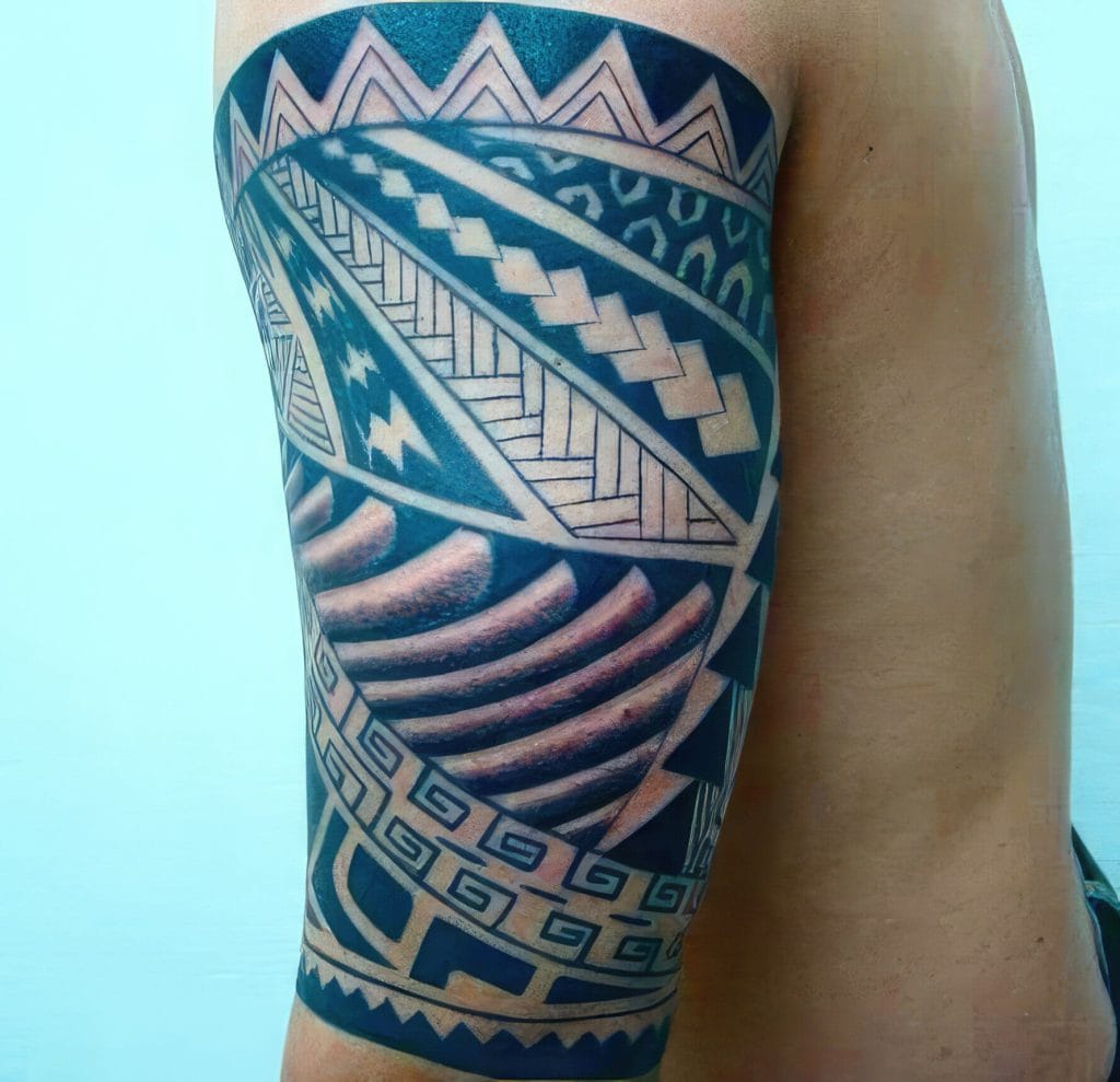 Detailed Polynesian-style tattoo covering the upper arm and shoulder.