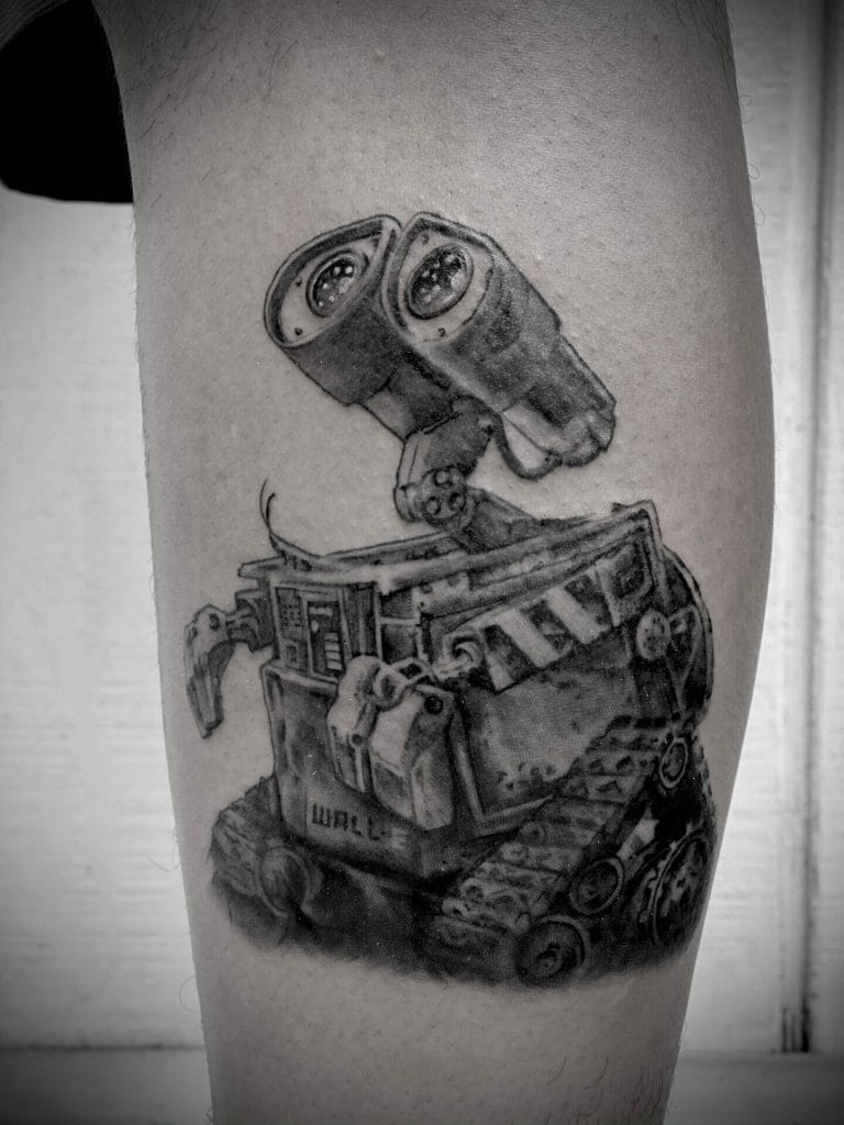 Tattoo of WALL-E robot with binoculars on its head, detailed and shaded in black and gray.