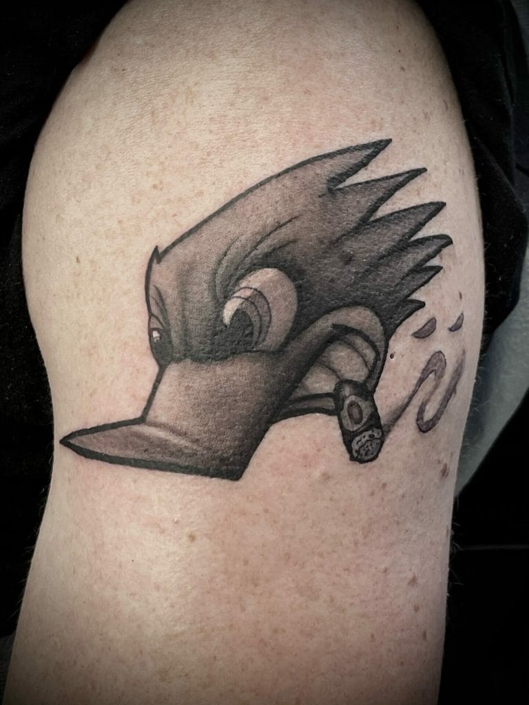 Stylized bird with a mohawk, wearing a small earring, facing left.