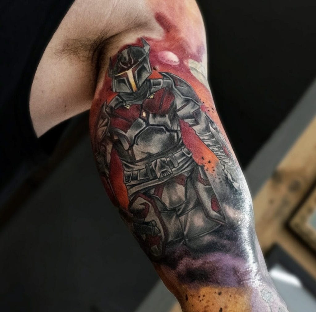 Detailed tattoo of a Mandalorian character from Star Wars on a persons upper arm.