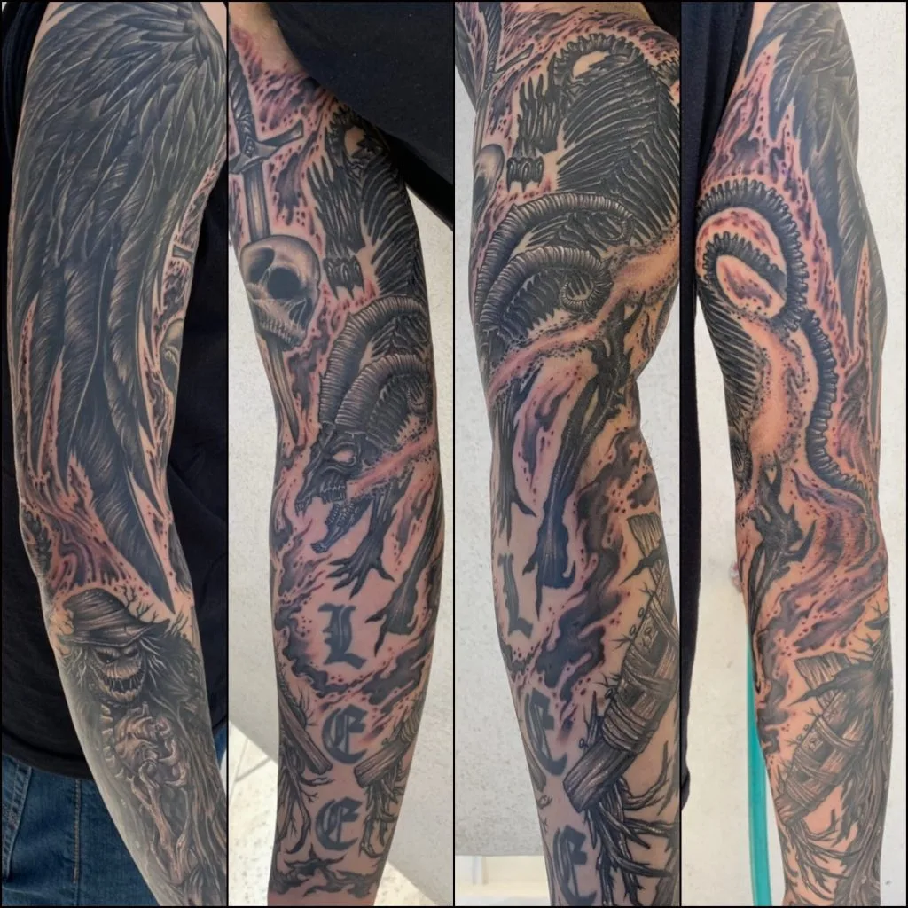 Black and gray tattoo sleeve featuring a skull, a dragon, a sword, and a serpent.