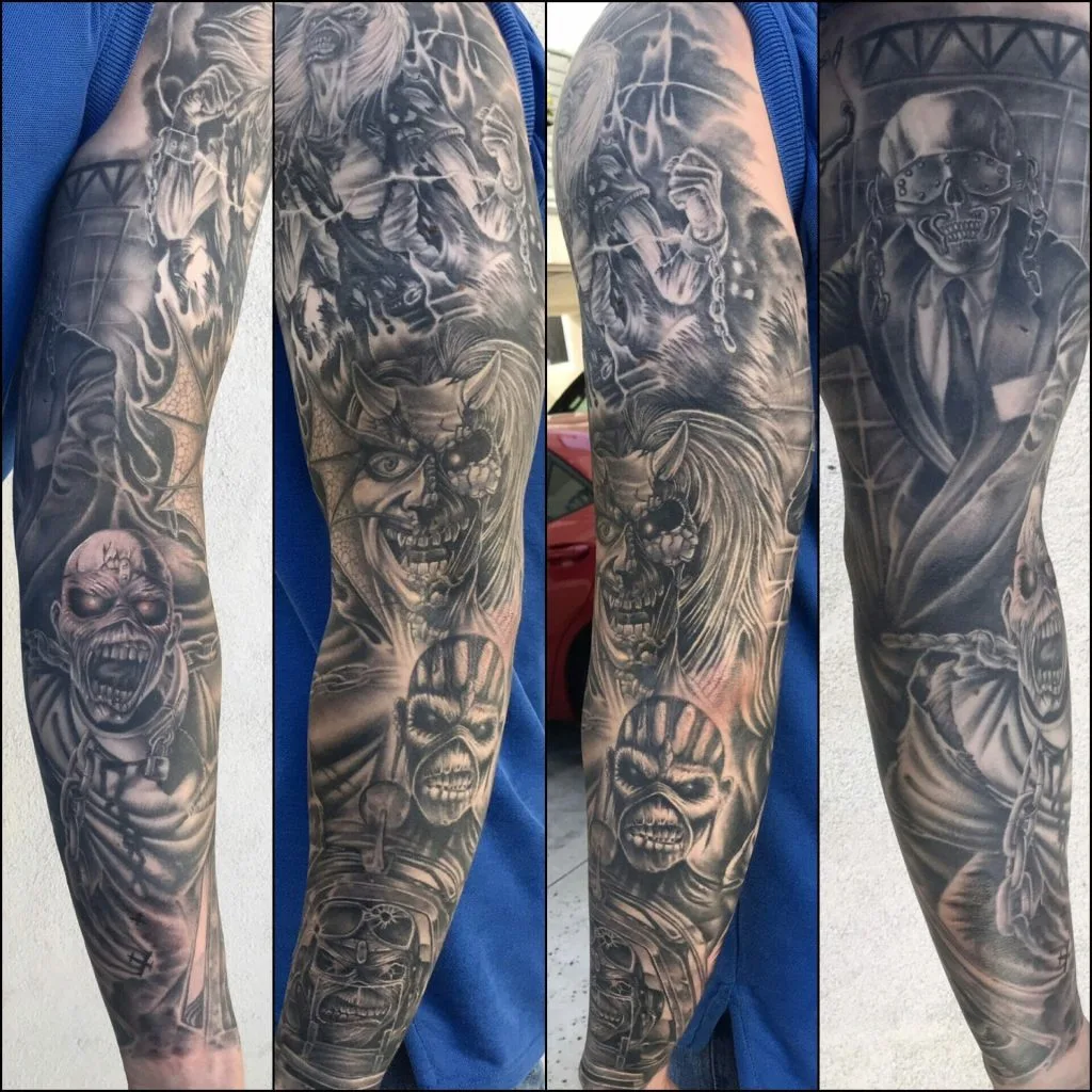 Black and gray tattoo sleeve featuring a clown, zombie, demon, and skull with chains.