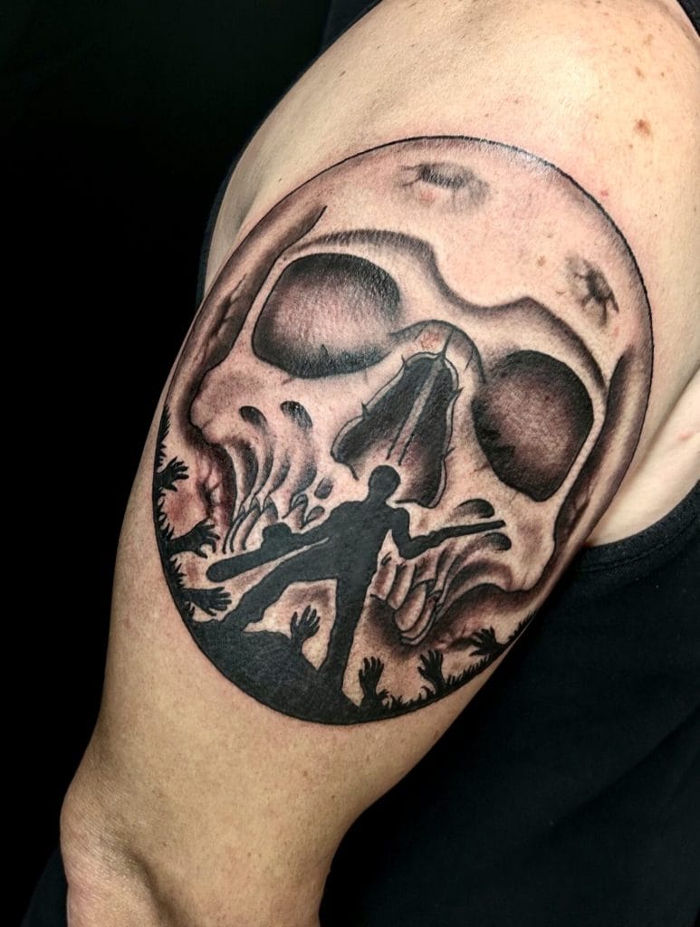 Silhouette of a person reaching toward a large skull with a moonlit sky and trees in the background.