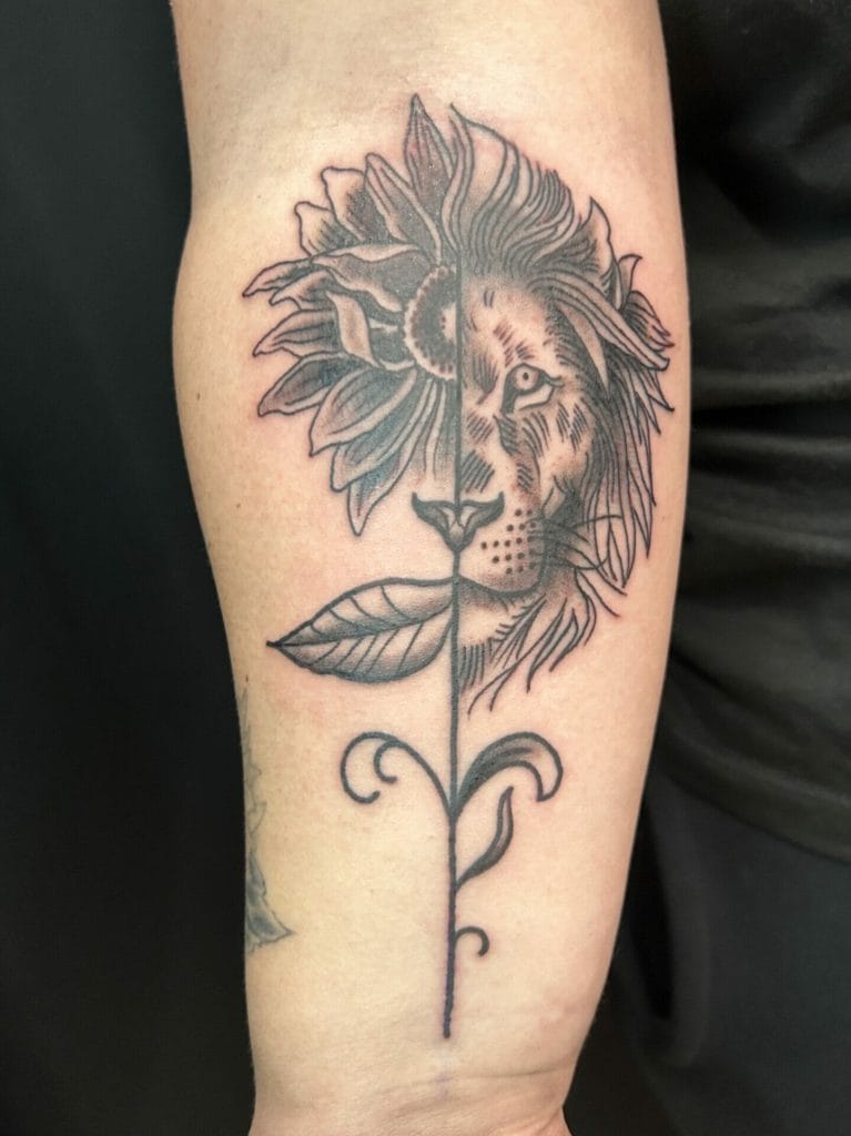 Tattoo of a lions face with a sunflower as the mane, blending into a leaf and stem design.