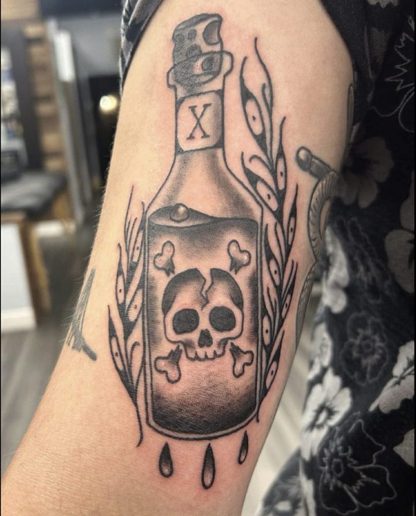 Skull and bones inside a bottle with dripping liquid, surrounded by wheat stalks.