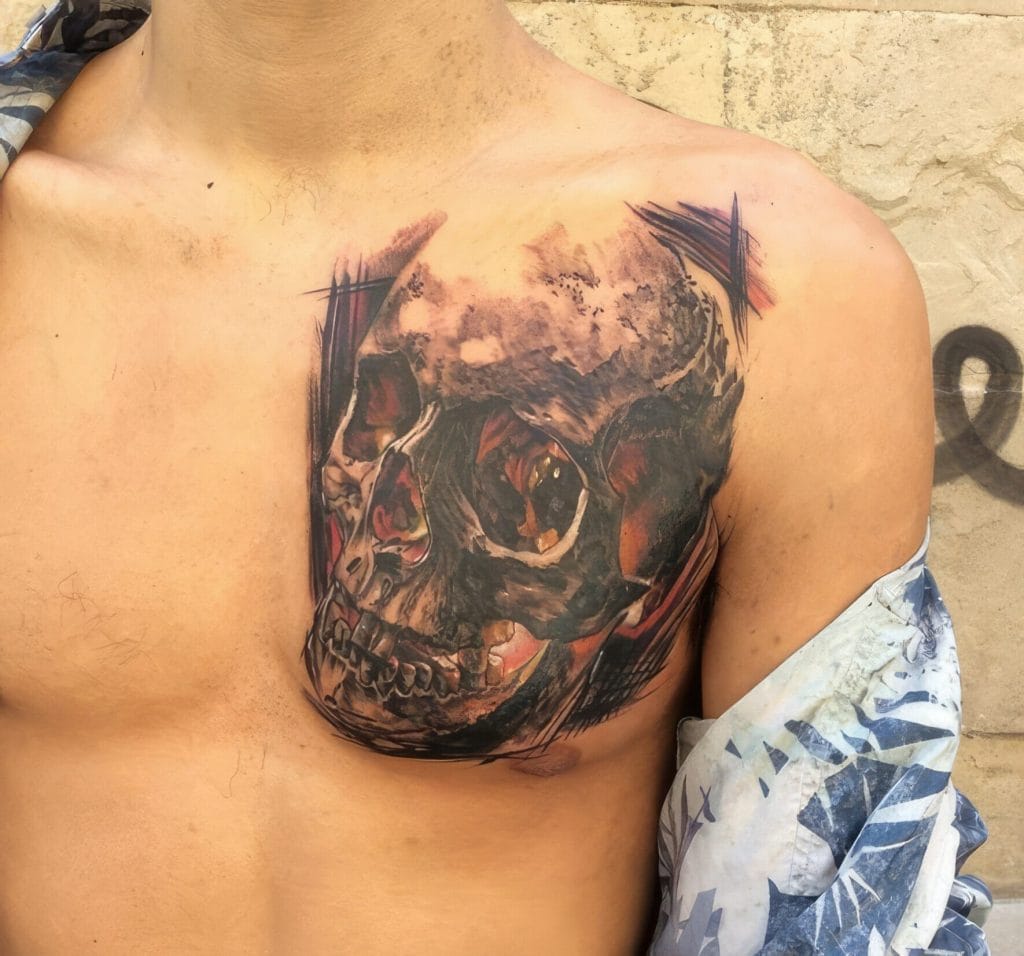 Realistic skull tattoo on persons chest with dark shading and detailed features.