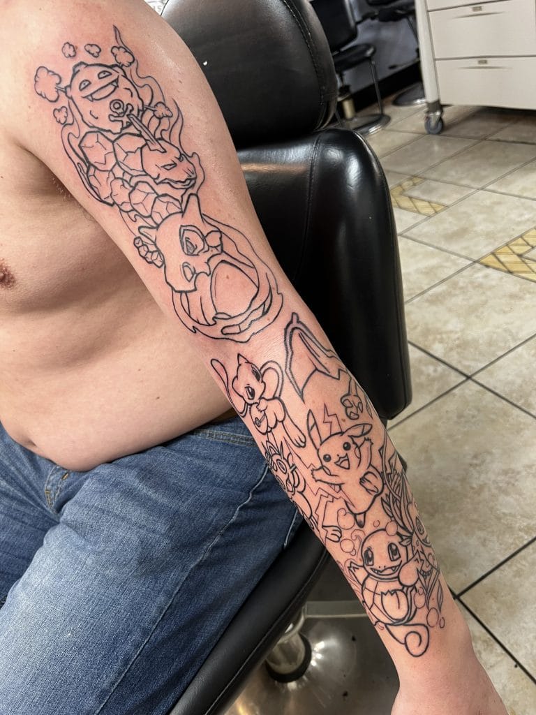 Outline of a Pokémon-themed tattoo sleeve featuring Pikachu, Eevee, Charizard, and a dragon.