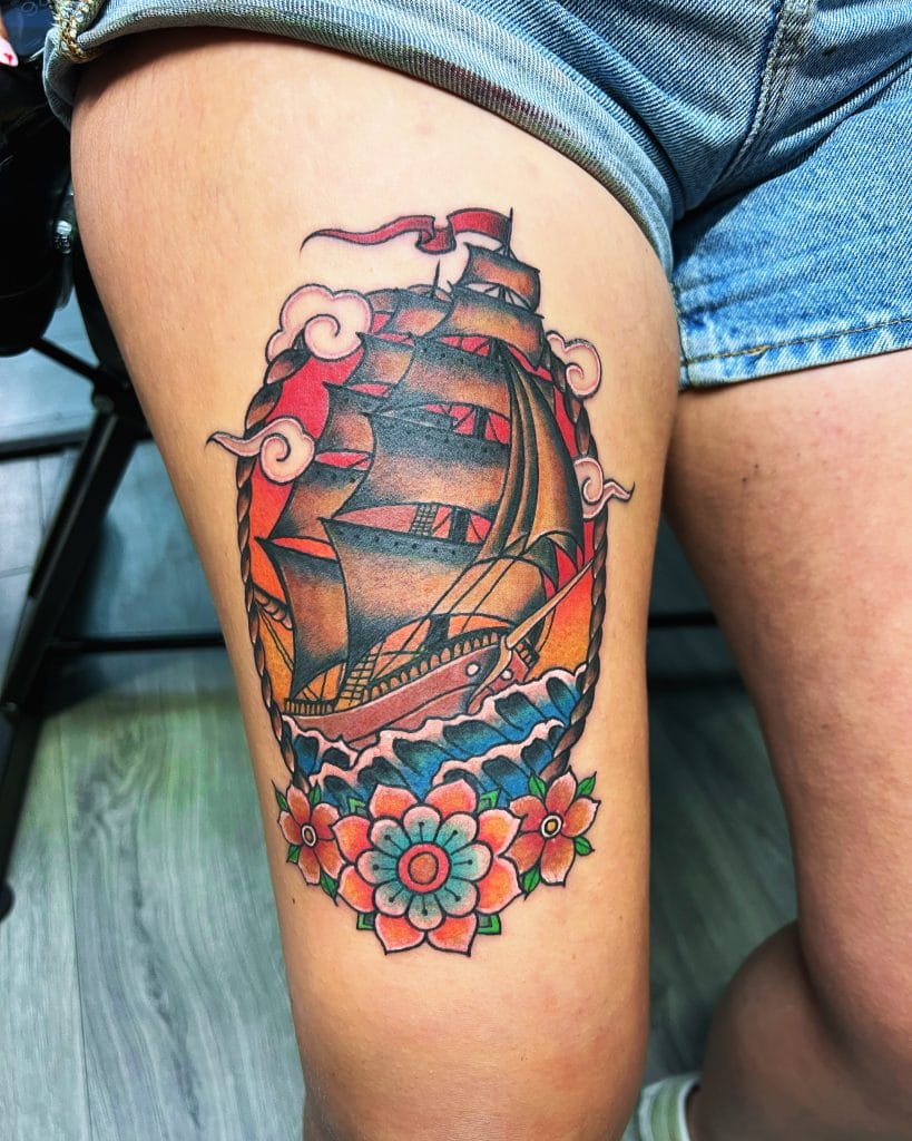 Colorful traditional-style ship sailing with flowers and clouds on thigh.
