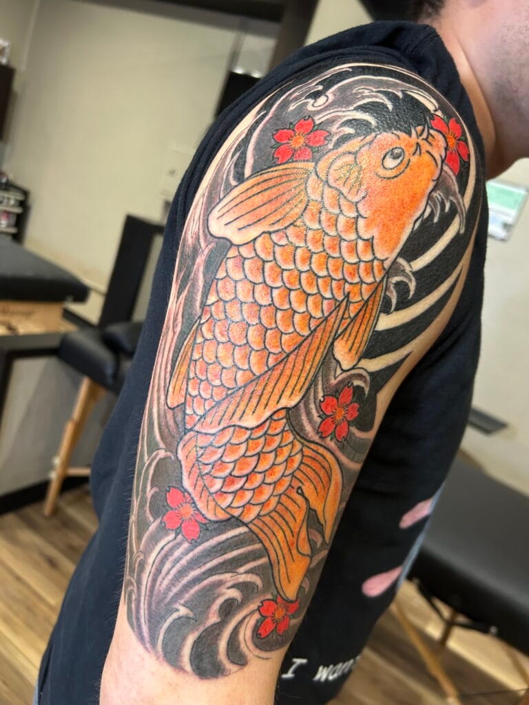 Koi fish swimming among stylized waves with red cherry blossoms around it.